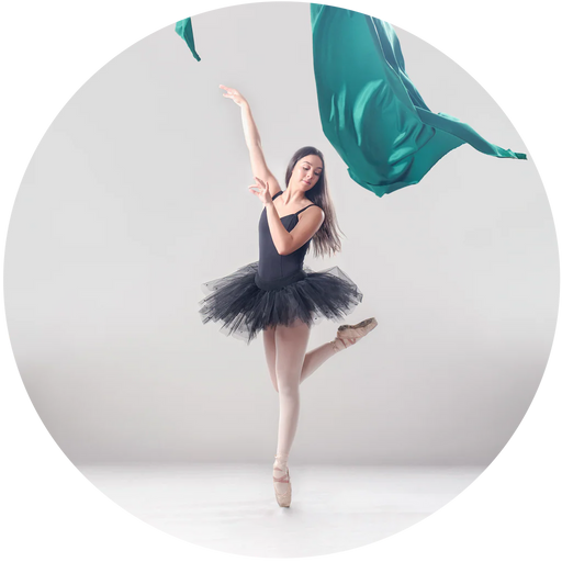 Ballerina in a black tutu posing with teal ribbons on a white background