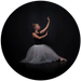 Ballerina in a black top and white tutu against a dark background